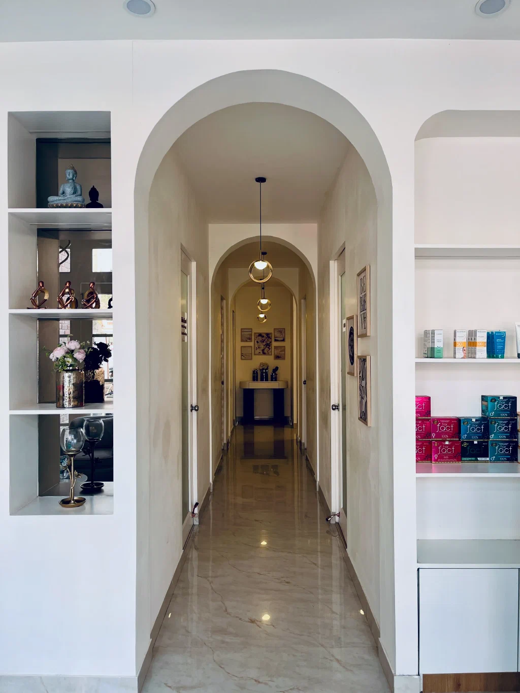 Elegant arched corridor inside Dr. Shikha Aesthetics with warm ambient lighting